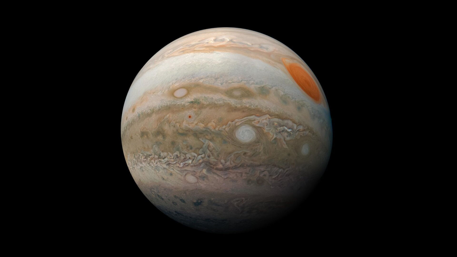 Jupiter vu par Junon, sa grande tache rouge visible à droite.